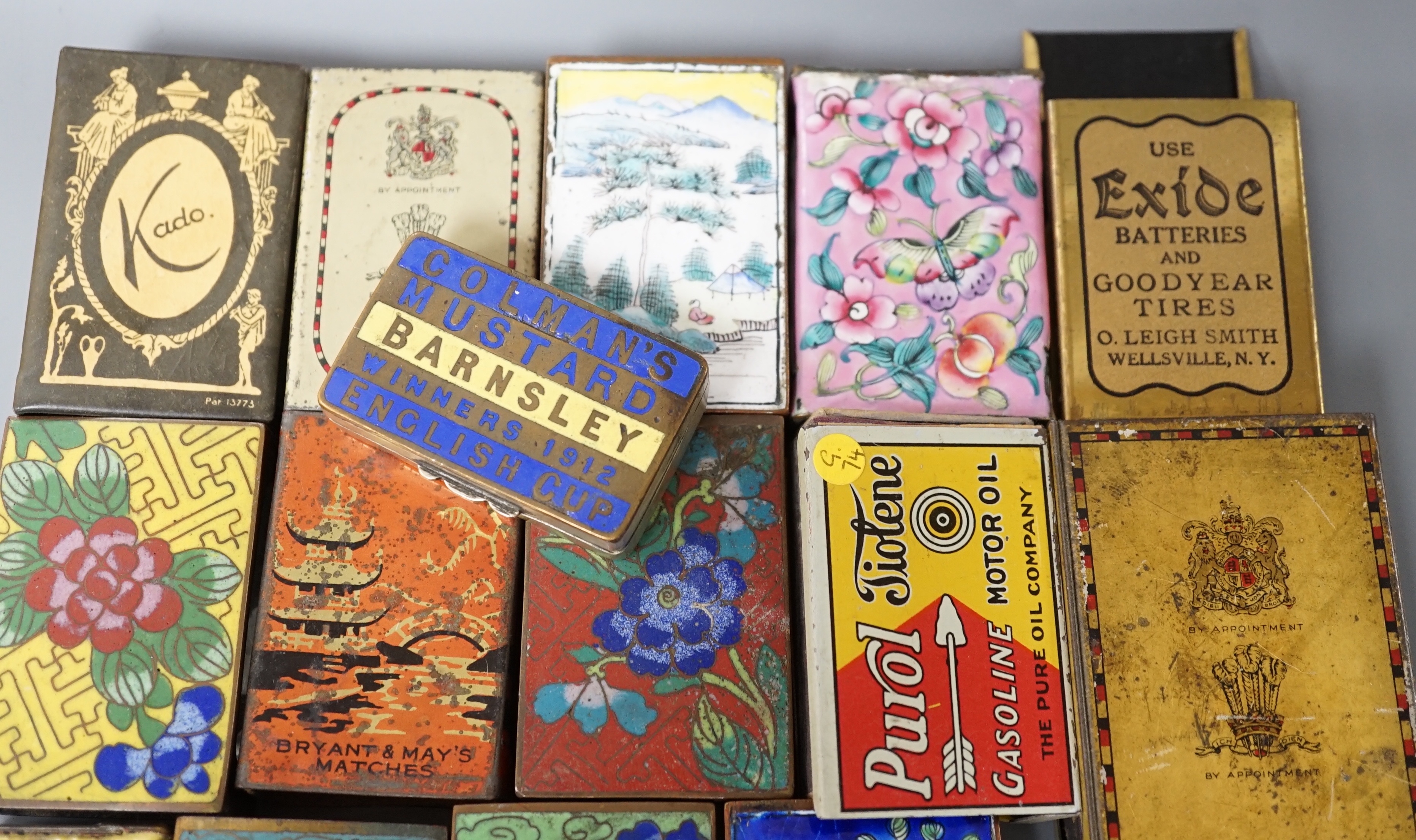 A collection of advertising and other enamelled metal match box holders